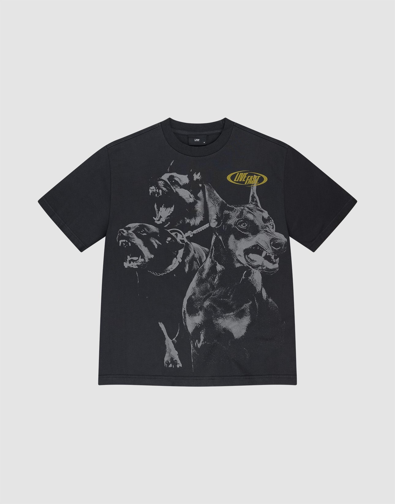 A man with braided hair wears the LIVE FAST DIE YOUNG LFDY Bark Tee, a black, vintage wash shirt with large dog graphics and yellow LIVE FAST text. He pairs it with bright yellow athletic shorts against a plain gray background.