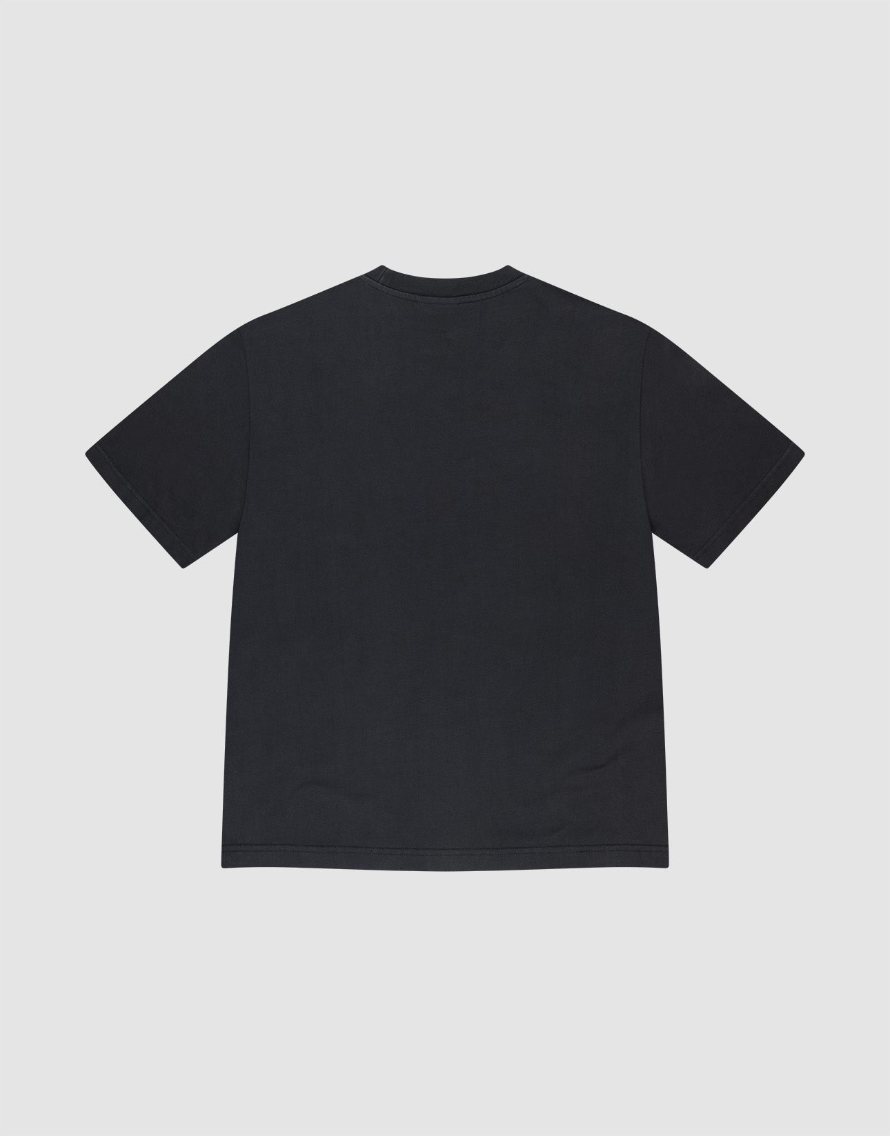 A man stands against a plain background wearing the oversized black LFDY Bark Tee by LIVE FAST DIE YOUNG, teamed with bright yellow shorts and white athletic shoes. His hands are in his pockets and he looks forward.