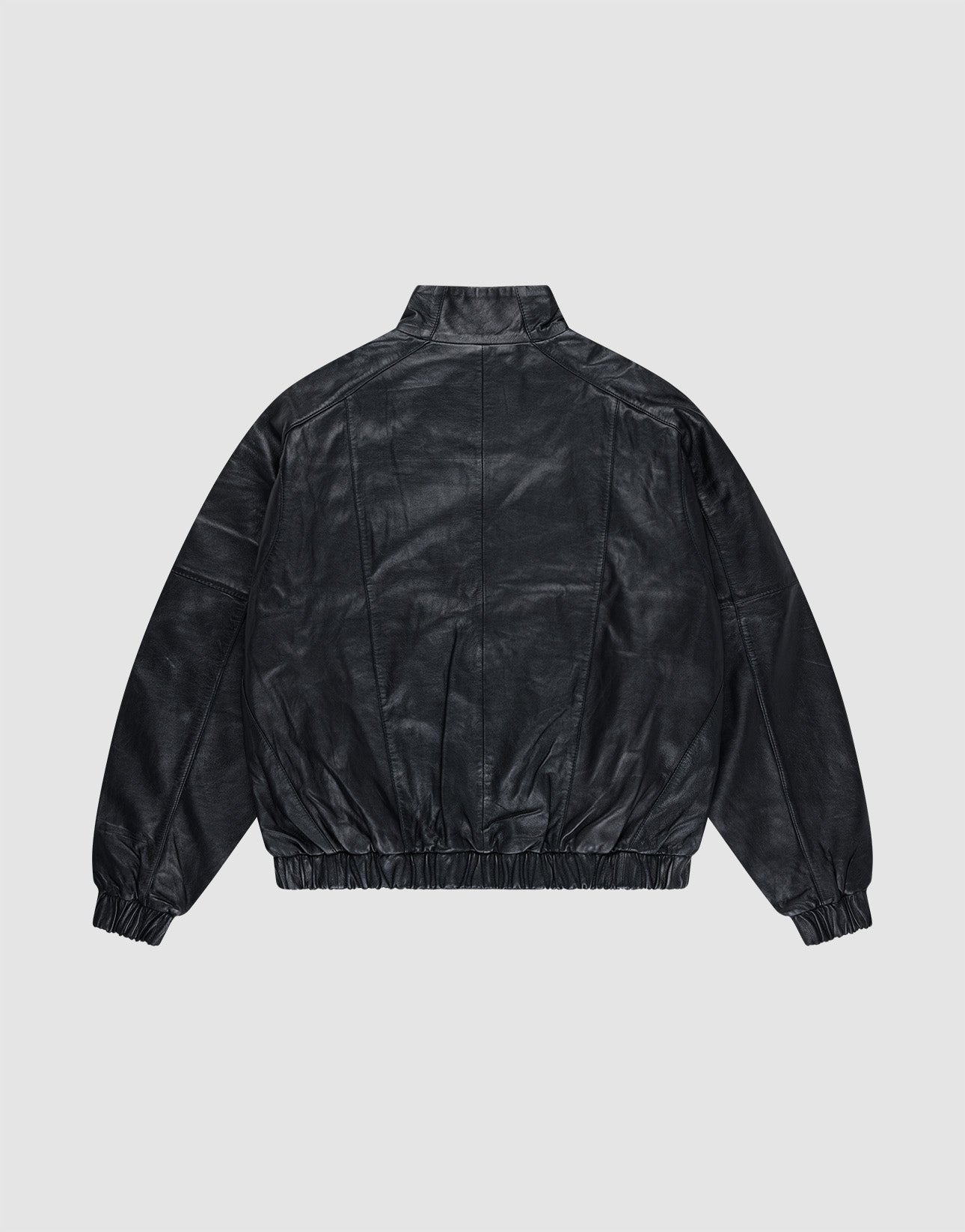 The Live Fast Leather Trackjacket by LIVE FAST DIE YOUNG is shown from the back on a light gray background, featuring a stand collar, relaxed fit, elastic cuffs and waistband, plus a subtly embossed logo.