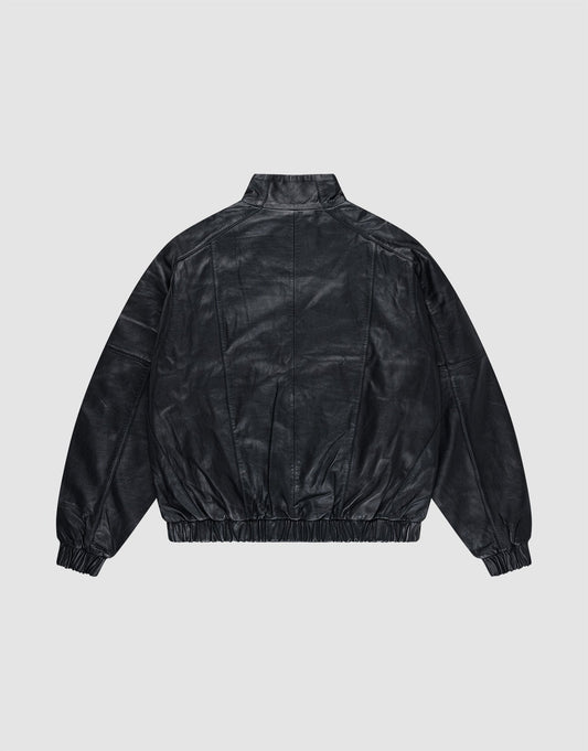 The Live Fast Leather Trackjacket by LIVE FAST DIE YOUNG is shown from the back on a light gray background, featuring a stand collar, relaxed fit, elastic cuffs and waistband, plus a subtly embossed logo.