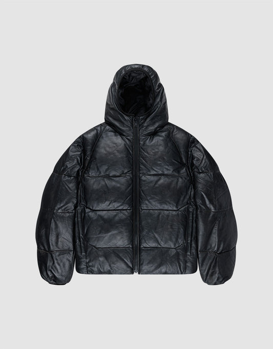 The Live Fast Leather Puffer Jacket by LIVE FAST DIE YOUNG is a black, oversized, hooded puffer made from shiny leather-like material with an embossed Live Fast logo and front zipper, shown on a plain light gray background. | plain