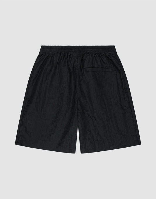 LIVE FAST DIE YOUNG’s Live Fast Nylon Shorts in black feature an oversized fit, an elastic waistband, and a single back pocket. Shown flat on a light gray background with the back view visible.