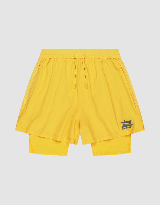 The LIVE FAST DIE YOUNG Live Fast Performance Running Shorts are bright yellow, Regular Fit, with an elastic waistband, drawstrings, double-layer design featuring integrated tights, and a blue shark logo with "LIVE FAST" on the lower left leg. | plain
