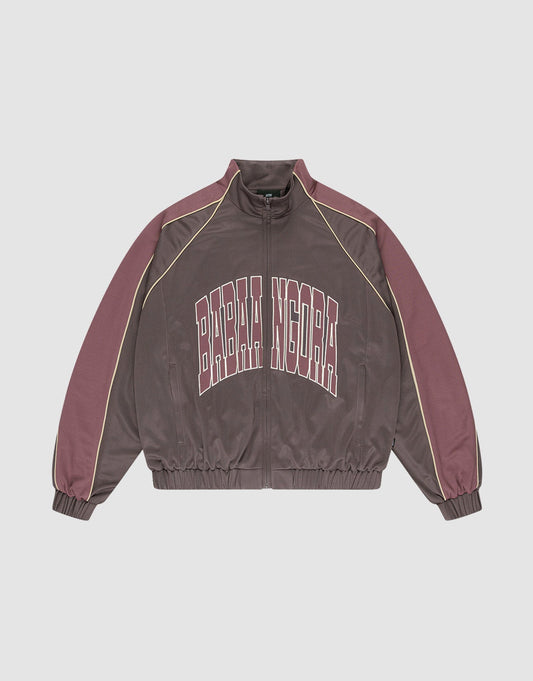 The LFDY x Baba Angora Trackjacket by LIVE FAST DIE YOUNG is a brown and mauve zip-up with beige sleeve piping, "BARBA NDORA" across the chest, an oversized fit, and elastic cuffs and hem for comfort. | plain