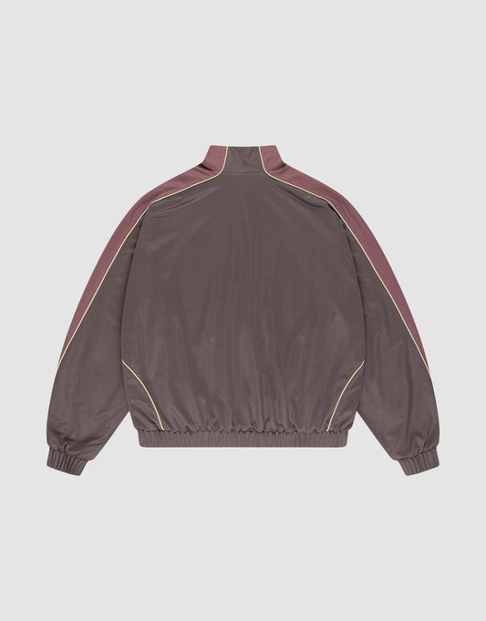 The LFDY x Baba Angora Trackjacket by LIVE FAST DIE YOUNG features a brown oversize fit, high collar, maroon shoulder and sleeve panels, yellow piping, and elastic cuffs and hem, shown on a plain white background.