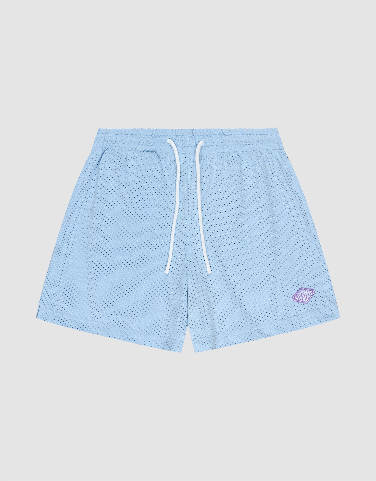 The LIVE FAST DIE YOUNG Basic Mesh Shorts are light blue, regular fit with an elastic waistband, white drawstrings, and a small purple logo patch on the lower left leg, shown against a plain light gray background. | plain