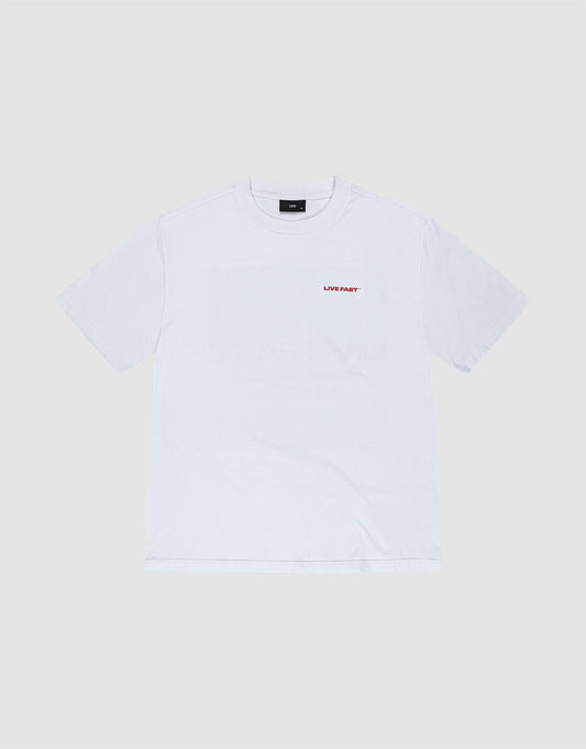 The LFDY Cinema Tee by LIVE FAST DIE YOUNG is an oversized white short-sleeve shirt made from 100% Baumwolle, featuring small red 'LIVE FAST' text on the left chest, shown against a light gray background.