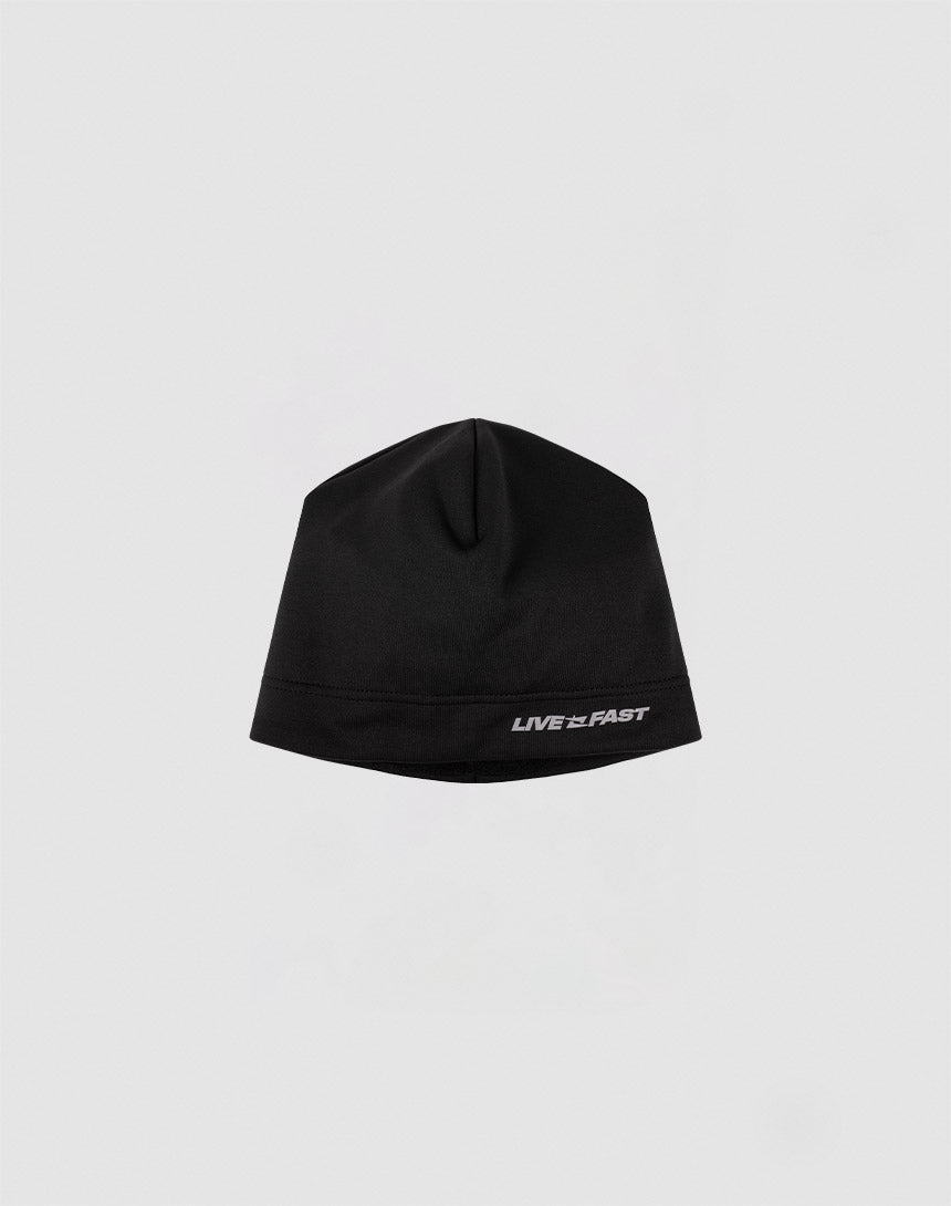 The Live Fast Performance Beanie by LIVE FAST DIE YOUNG features a black fitted design with a reflective LIVE FAST logo near the brim, shown against a plain light gray background.