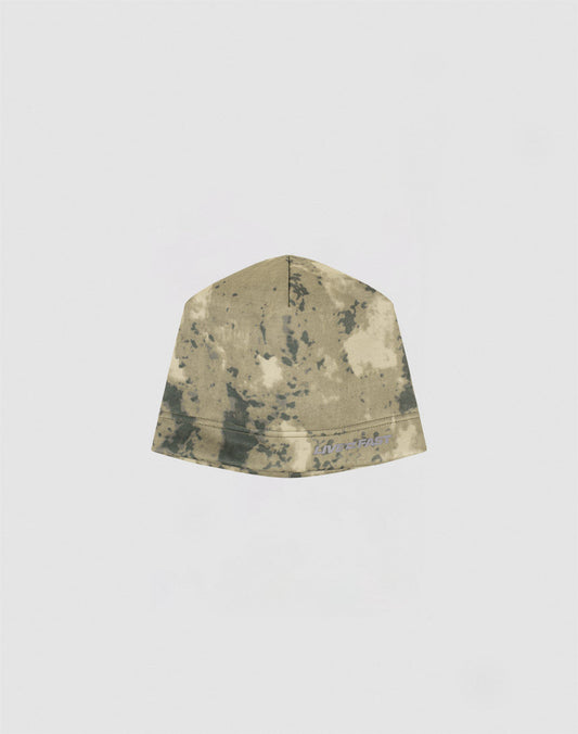 The Live Fast Performance Beanie by LIVE FAST DIE YOUNG, featuring a tan and dark green tie-dye design with a reflective logo print, is displayed against a plain light gray background.