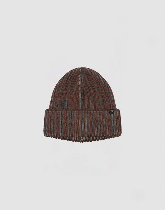 The LIVE FAST DIE YOUNG 2 Tone Rib Knit Beanie in brown Polyacryl has a folded brim and a small black flag label with white text, shown against a plain light grey background.
