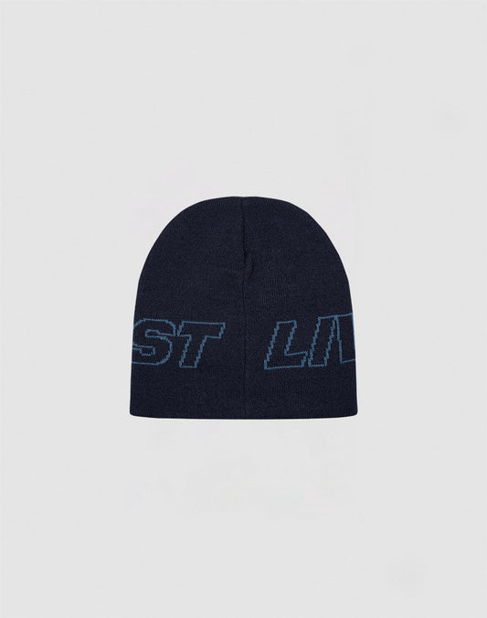 The Live Fast Jacquard Beanie by LIVE FAST DIE YOUNG is a dark navy polyacryl knit hat with light blue outlined “Logo Strick Outline” text wrapping around it, shown against a plain light gray background.