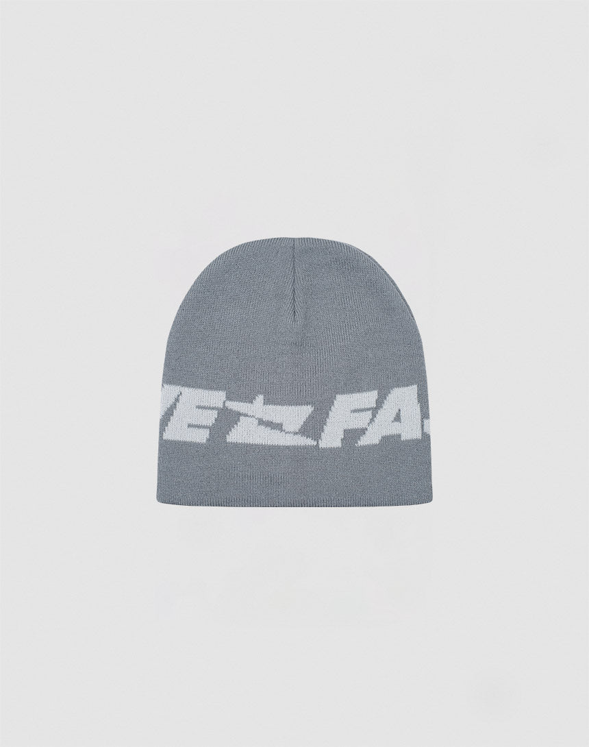 The Live Fast Jacquard Beanie by LIVE FAST DIE YOUNG is a soft gray polyacryl knit with a bold white Logo Strick graphic and partially visible text on the front. Model: LF2410-16486. 