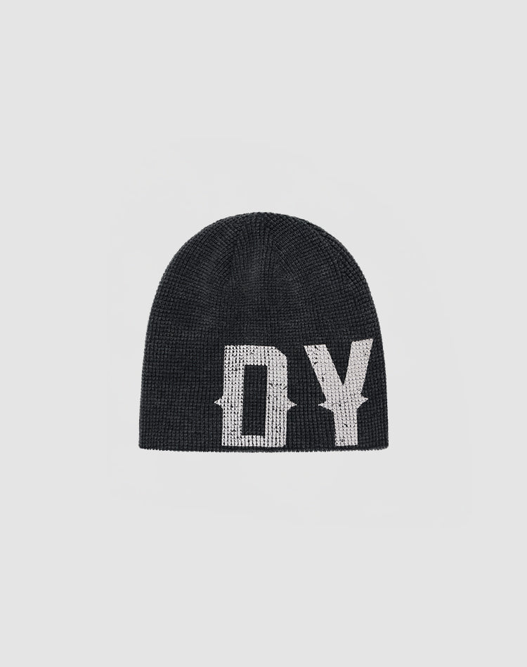 The DY Waffle Beanie by LIVE FAST DIE YOUNG is a black knit beanie with bold white DY lettering and a handgefertigter Sprayeffekt, shown on a plain light gray background.| plain 