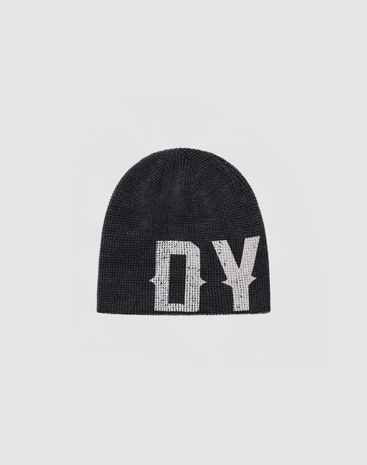 The DY Waffle Beanie by LIVE FAST DIE YOUNG is a black knit beanie with bold white DY lettering and a handgefertigter Sprayeffekt, shown on a plain light gray background.| plain 