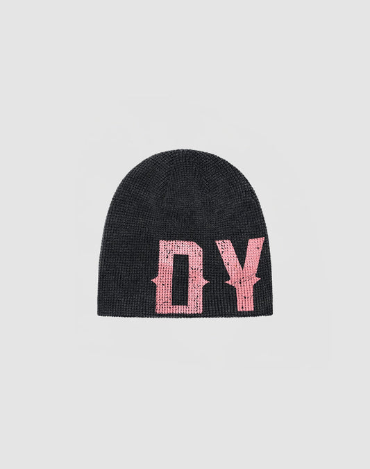 The DY Waffle Beanie by LIVE FAST DIE YOUNG is a black knit hat with bold pink stylized “DY” letters in a spray effect on the front, displayed on a simple light gray background.| plain 