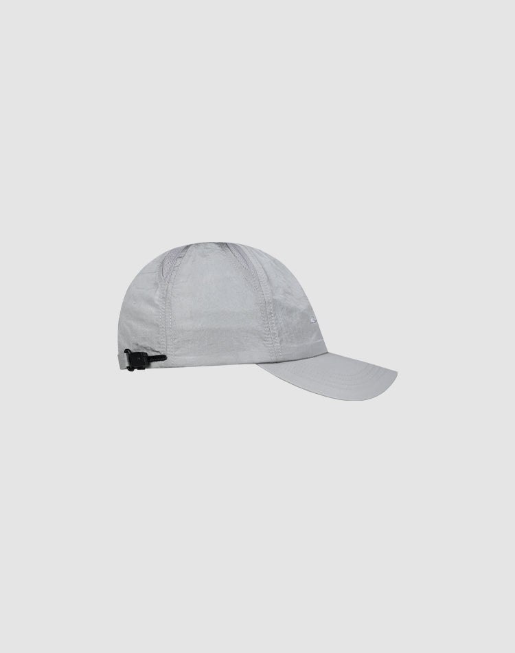 The LFDY Performance Cap by LIVE FAST DIE YOUNG is a light gray baseball hat made from lightweight nylon, featuring a curved brim, subtle logo print, and an adjustable black strap, shown on a plain light background.