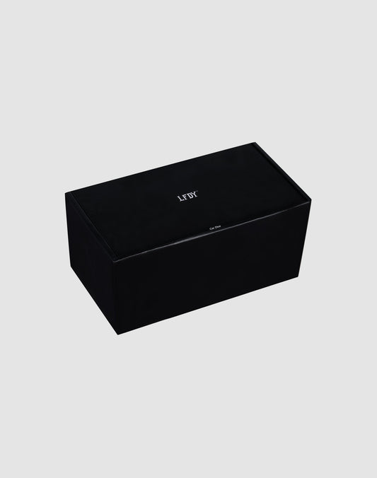 A rectangular black LFDY Leather Car Dice by LIVE FAST DIE YOUNG, featuring "LEFT" in white on top, displayed on a plain light gray background.