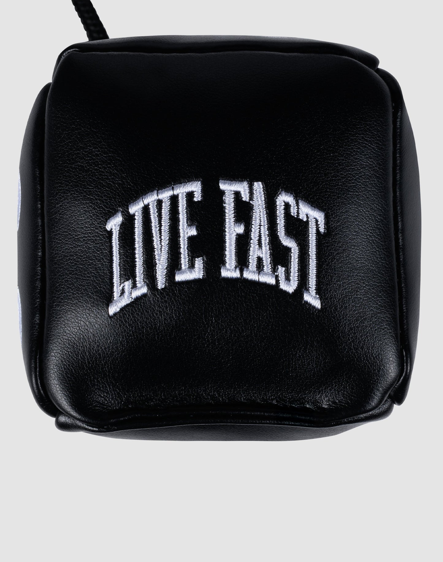 A black PU-leather pouch from LIVE FAST DIE YOUNG, featuring "LIVE FAST" embroidered in bold white arched capitals on the front, designed to hold the LFDY Leather Car Dice.