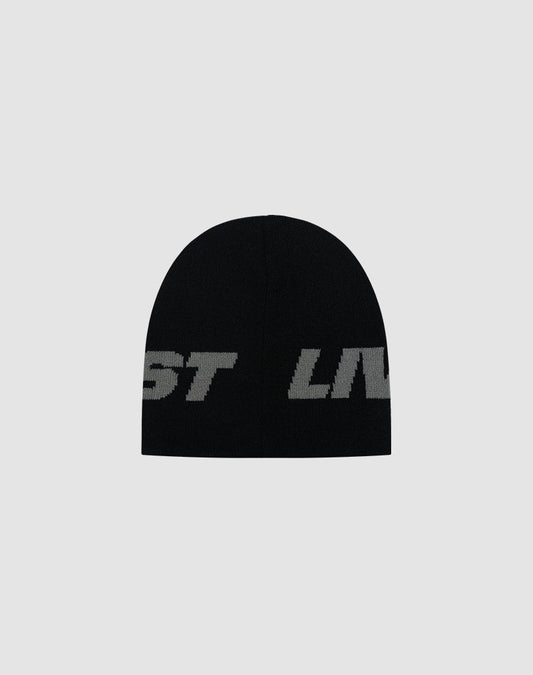 The Live Fast Jacquard Beanie by LIVE FAST DIE YOUNG is a black polyacryl hat featuring large, bold gray jacquard logo lettering, partially visible against a plain light gray background. LF2504-17542.