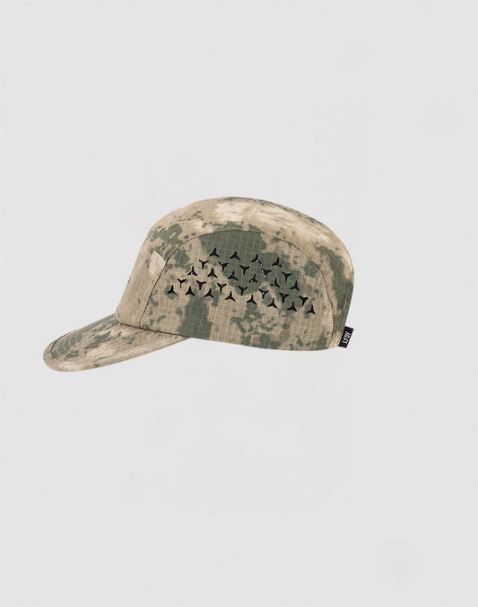 The LIVE FAST DIE YOUNG Live Fast 5 Panel Cap is a camouflage-patterned nylon cap with a cluster of black geometric air holes on the side, shown against a plain light gray background.