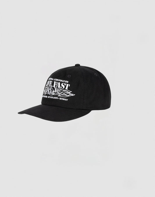 The Live Fast Corporation Cap by LIVE FAST DIE YOUNG is a black, 100% cotton unstructured 5-panel hat with bold white text and Multi-Logo designs on the front, shown against a plain light gray background.