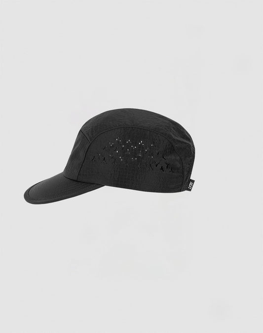 The LIVE FAST DIE YOUNG Live Fast 5 Panel Cap features durable black nylon, a curved brim, small laser-cut side vents, and a subtle silicone print—shown here against a plain light grey background.