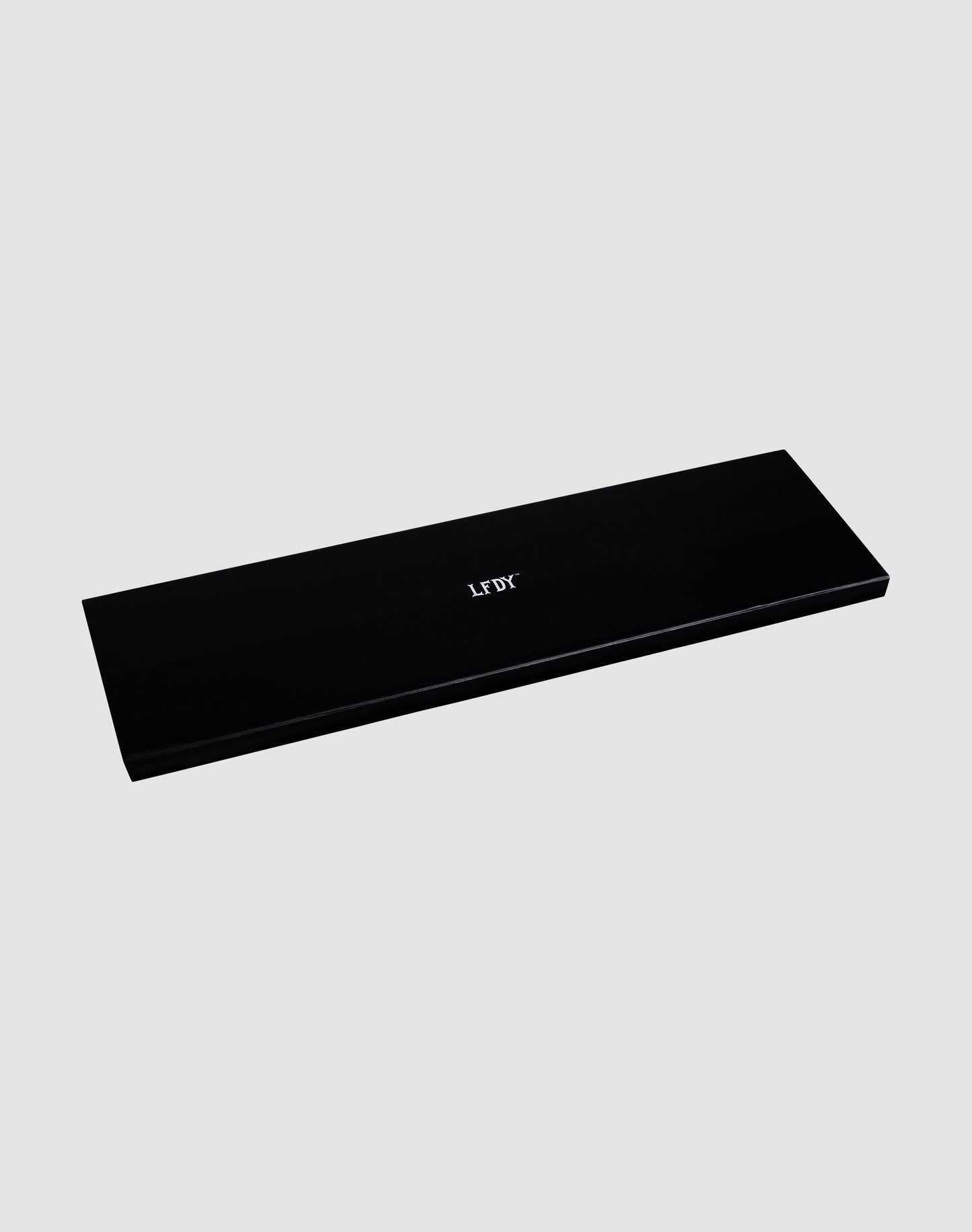 A rectangular, black box with "JOU" and a subtle white LFDY logo centered on it contains the LFDY License Plate Holder (2 Pack) by LIVE FAST DIE YOUNG, set against a plain light gray background.