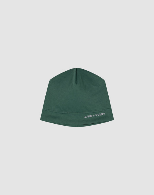 The Live Fast Performance Beanie by LIVE FAST DIE YOUNG is a fitted green hat featuring a small reflective white LIVE FAST logo print on the lower right, shown against a plain light gray background.