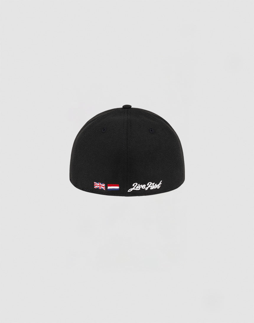 The LFDY x NEW ERA 59FIFTY Low Profile by LIVE FAST DIE YOUNG is a black fitted cap with British and Indonesian flag patches and white 2wo Point text above the back edge, shown against a plain light gray background.