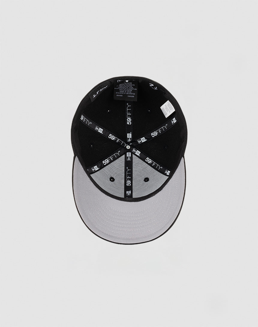 The LFDY x NEW ERA 59FIFTY Low Profile cap by LIVE FAST DIE YOUNG features black panels, a grey underbrim, a low profile silhouette, and branded 59FIFTY taping along the inner seams.