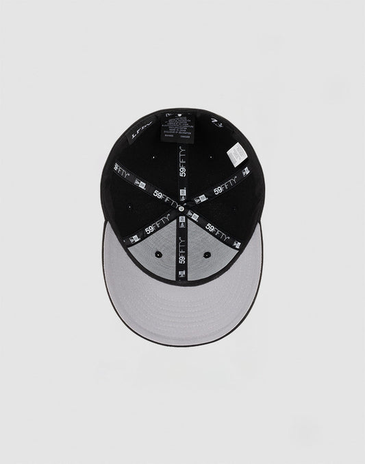 The LFDY x NEW ERA 59FIFTY Low Profile cap by LIVE FAST DIE YOUNG features black panels, a grey underbrim, a low profile silhouette, and branded 59FIFTY taping along the inner seams.