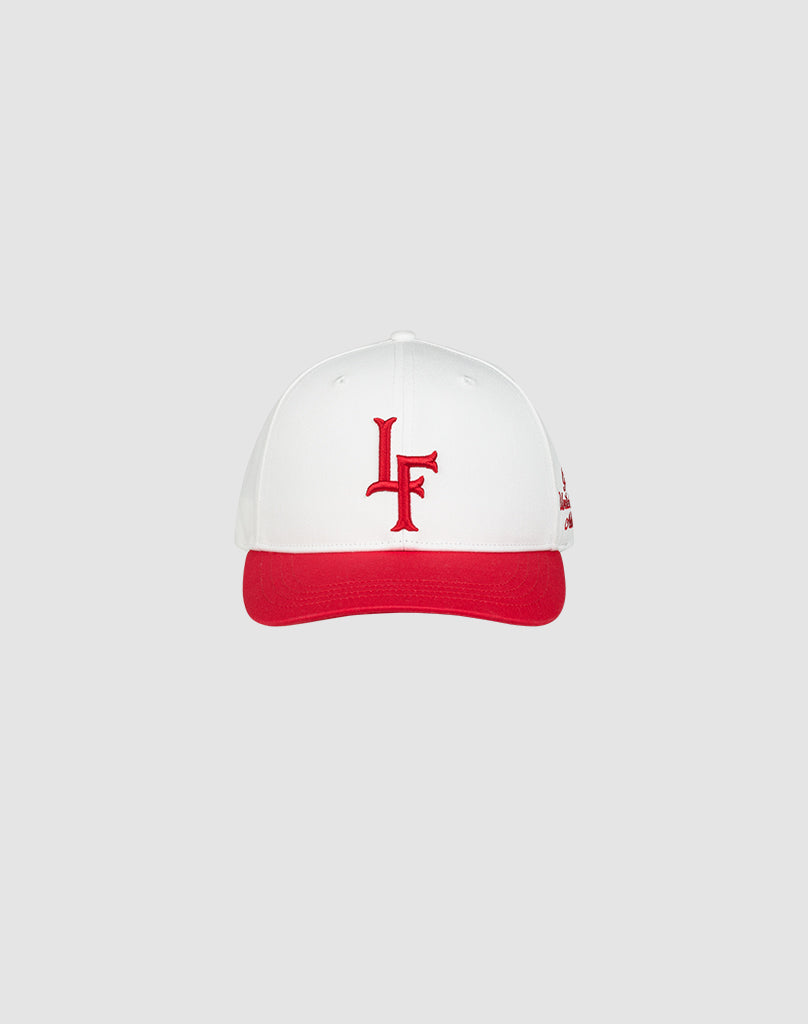 The LF Snapback by LIVE FAST DIE YOUNG features a white design with red brim, red LF logo embroidery on the front, made from 100% cotton and finished with a snapback closure, showcased against a simple light grey background.