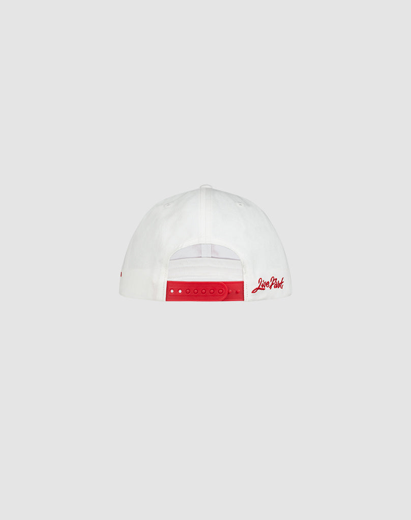 A white LF Snapback by LIVE FAST DIE YOUNG shown from the back, featuring a red Mit Snapverschluss adjustable strap and red Love Field embroidery on the right side. Made from 100% Baumwolle. Set against a light gray background.